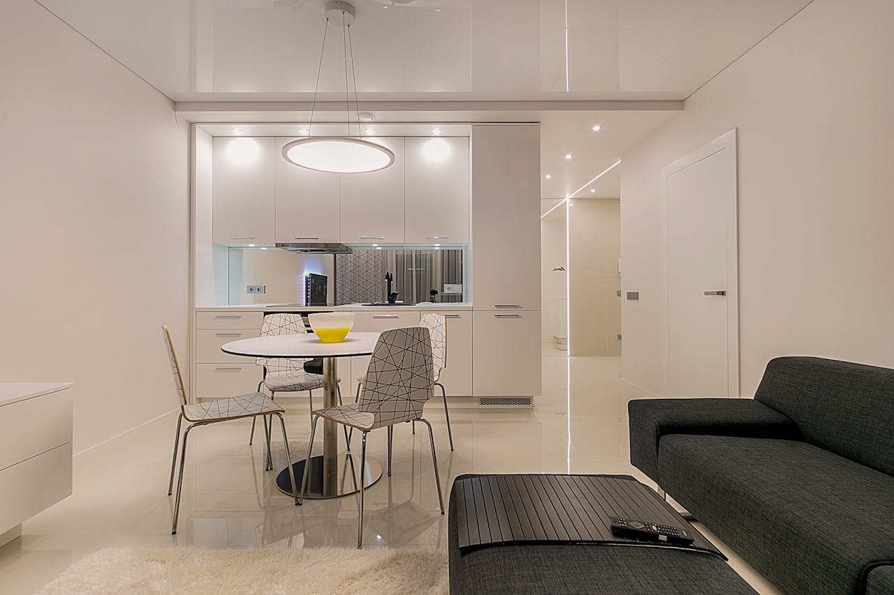Stylish contemporary open-plan living room and kitchen with minimalist design in Vilnius.